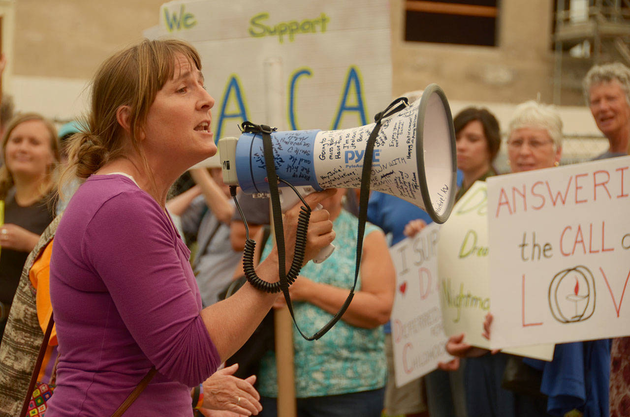 Nikki Russell of Port Townsend leads more than 50 people in a chant for unity at a protest at Adams Street Park in Port Townsend against the Trump administration’s announcement moving to end the Deferred Action for Childhood Arrivals program. (Cydney McFarland/Peninsula Daily News)