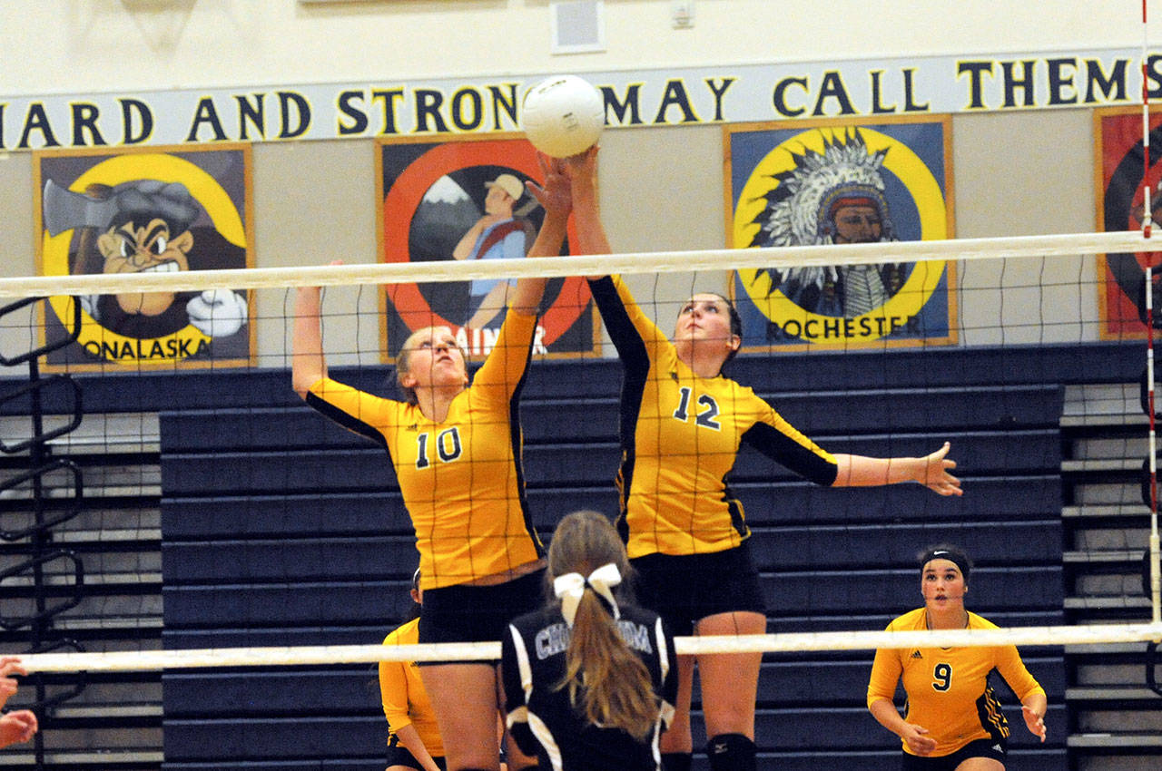 Forks’ Chloe Leverington (10) and Bailey Queen (12) go for the spike against Chimacum. The Spartans swept Chimacum in three sets in the season opener for both teams. (Lonnie Archibald/for Peninsula Daily News)