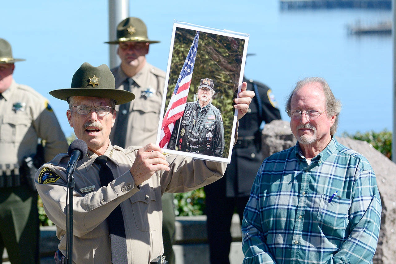 Clallam County Sheriff Bill Benedict, left, presents a photo to Alan Barnard on Monday, thanking him for his dedication that made the 9/11 Memorial Waterfront Park in Port Angeles possible. (Jesse Major/Peninsula Daily News)