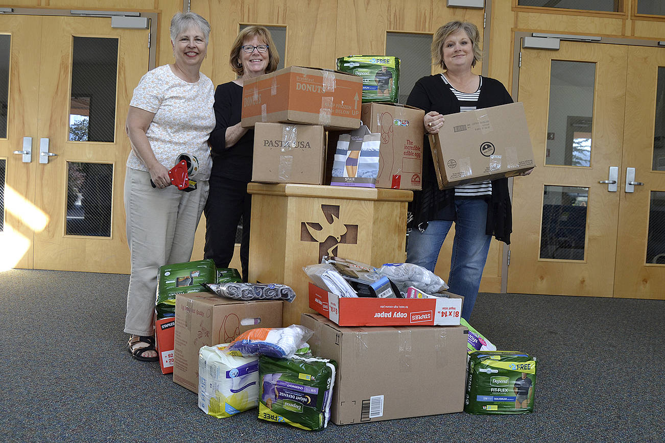 More than 1,000 new undergarments were packed and shipped Monday from Sequim’s Dungeness Valley Lutheran Church to Texas as support for Hurricane Harvey victims. Volunteers Sue Brock, Kathy Lohrman and Andra Smith, from left, helped lead the effort with an “Undie Sunday” donation drive the day before at the church. (Matthew Nash/Olympic Peninsula News Group)