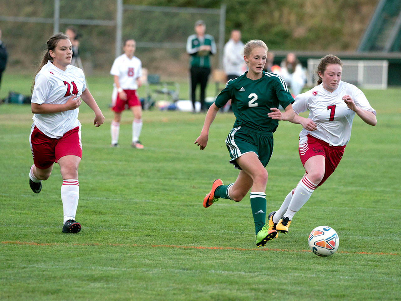 Port Angeles’ Millie Long, (2), races Port Townsend’s Nylah Garling, (7), for control of the ball as Margeaux Manuel, (24), assists in the Roughriders’ 6-0 win Tuesday. (Steve Mullensky/for Peninsula Daily News)