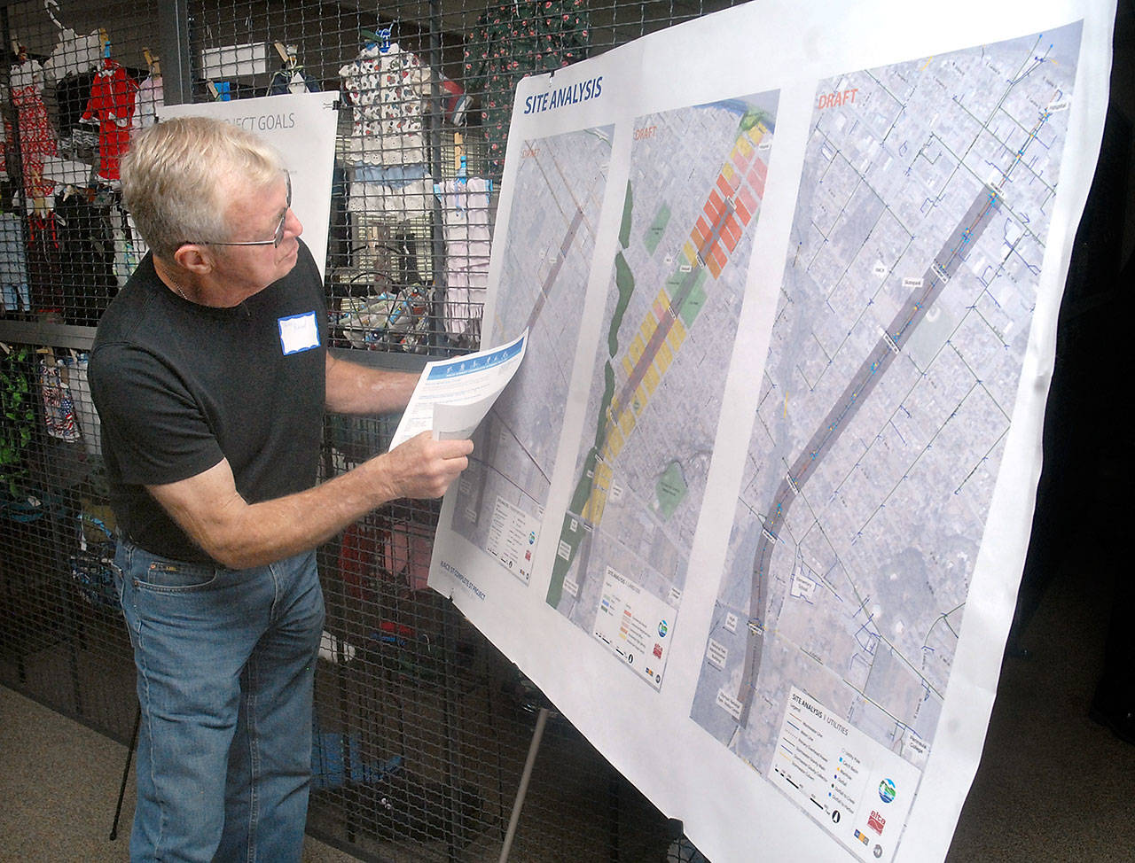Jim Reed of Sequim examines a set of maps of the Race Street corridor during an open house at the Port Angeles Senior & Community Center on Tuesday about potential changes to the route between First Street and Hurricane Ridge Road. (Keith Thorpe/Peninsula Daily News)