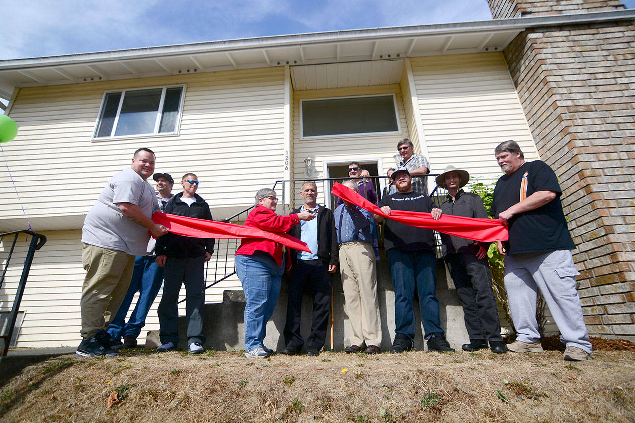 Oxford House residents celebrated the opening of the sixth Oxford House in Port Angeles on Saturday with a ribbon-cutting and an open house. (Jesse Major/Peninsula Daily News)