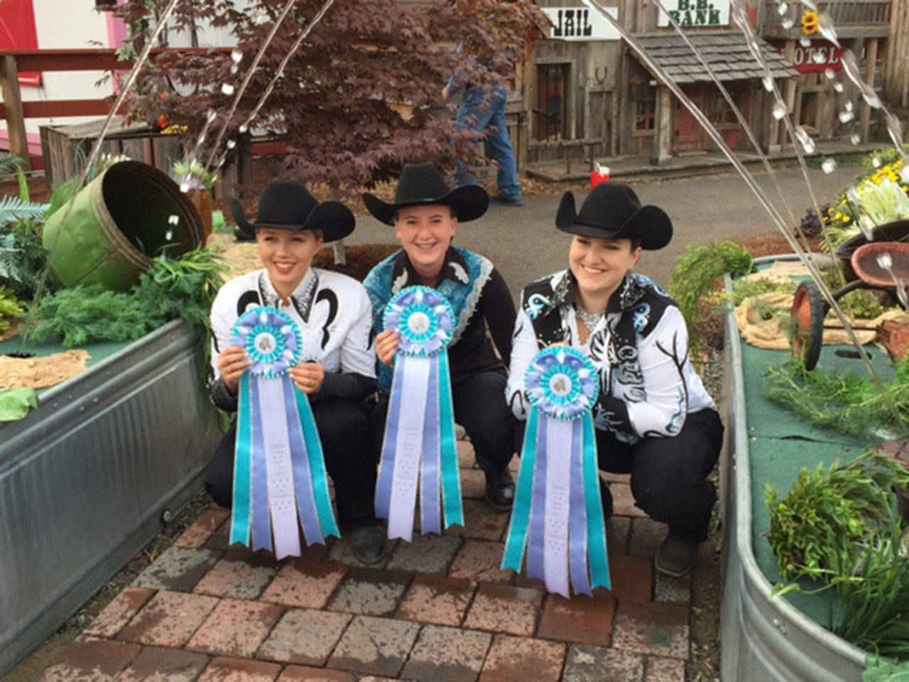 Senior division 4-H performance horse riders Emily Menshew, Kaylie Graf and Holly Cozzolino, from left, are all smiles for attaining all blue ribbons at the Western Washington State Fair in Puyallup from Sept. 7-11. They competed in showmanship, hunt seat, stock seat, disciplined rail, bareback and trail. (Russelle Graf)