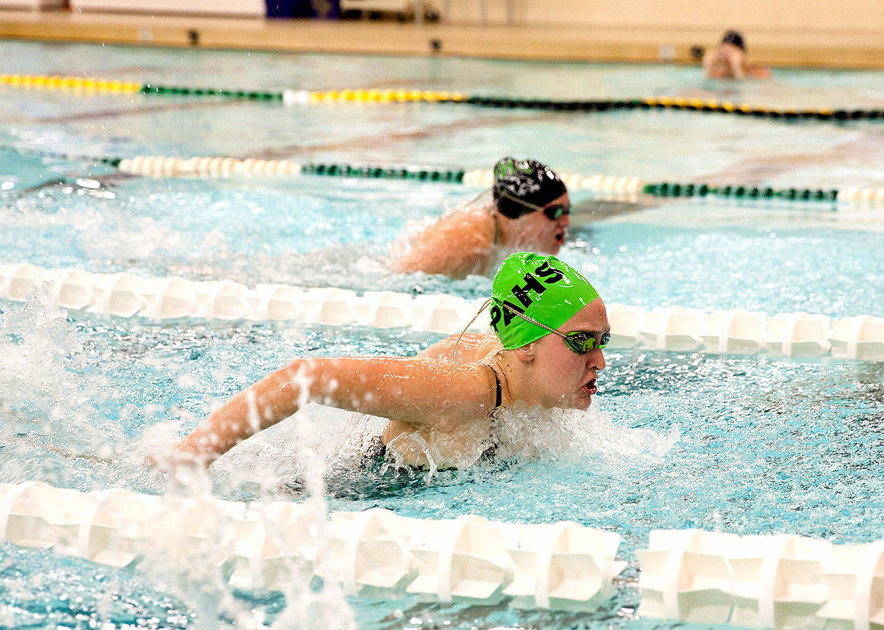 Patty Reifenstahl Port Angeles’ Emma Murray (in green cap) wins the 100 butterfly against Peninsula High School on Tuesday.