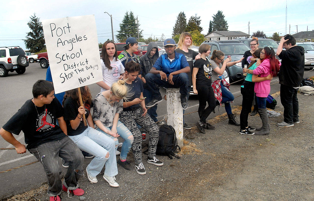 Port Angeles High School students, along with a few parents, gather across the street from the school Friday in protest of bullying at the high school. (Keith Thorpe/Peninsula Daily News)