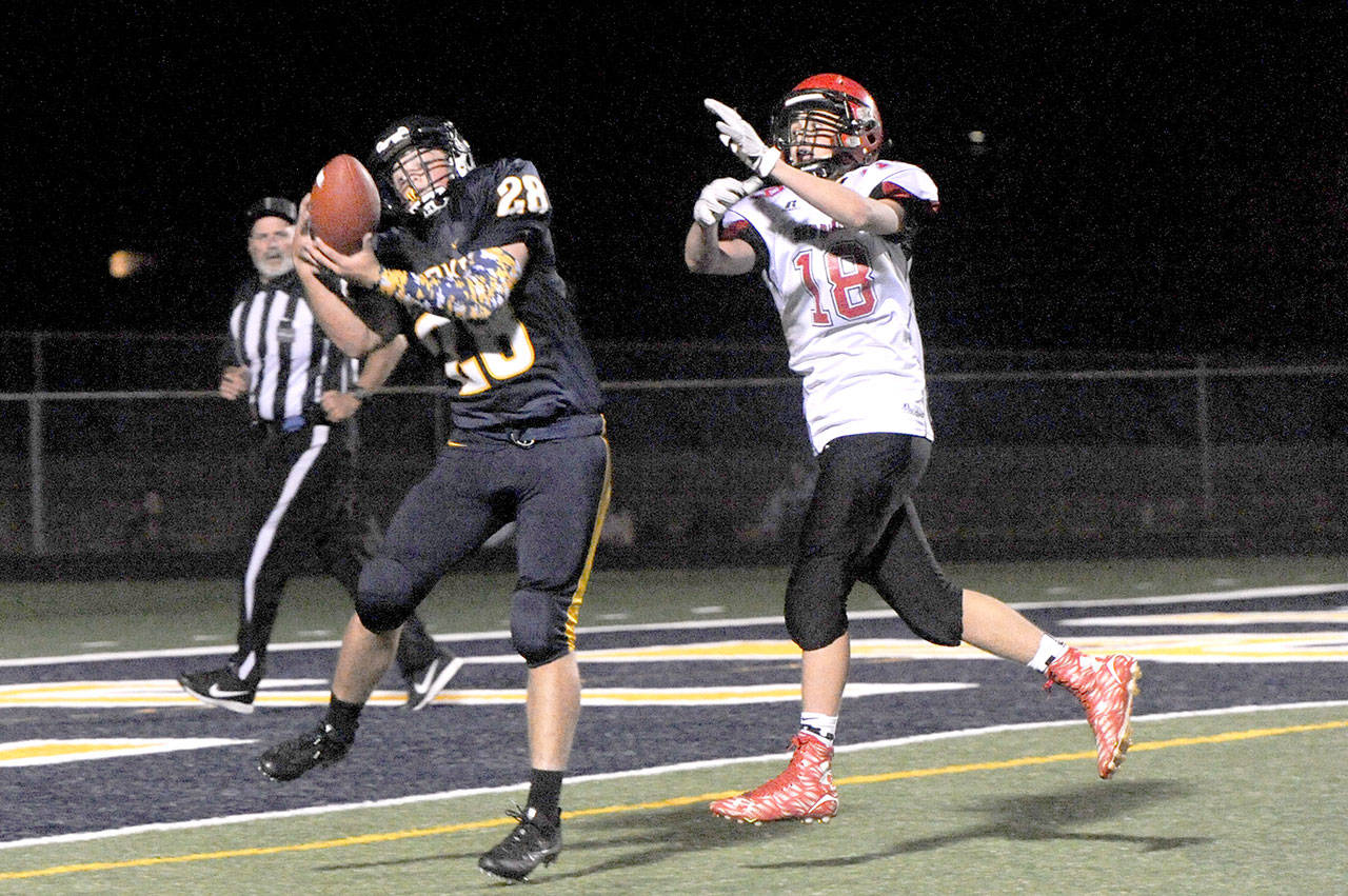 Lonnie Archibald/for Peninsula Daily News Forks’ Reece Blattner pulls in a pass at the 1-yard line and scores on a 24-yard touchdown pass from Gabe Reaume. Defending for Neah Bay is Josey Tyree.