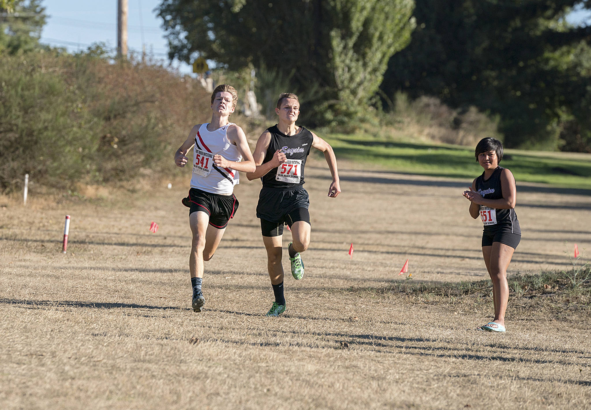Steve Mullensky/for Peninsula Daily News                                 Port Townsend&rsquo;s Nathan Cantrell, left, and Sequim&rsquo;s Murray Bingham sprint to the finish during a cross country meet at Port Townsend Golf Club. Cantrell took the lead in the last 20 meters to pick up the win.