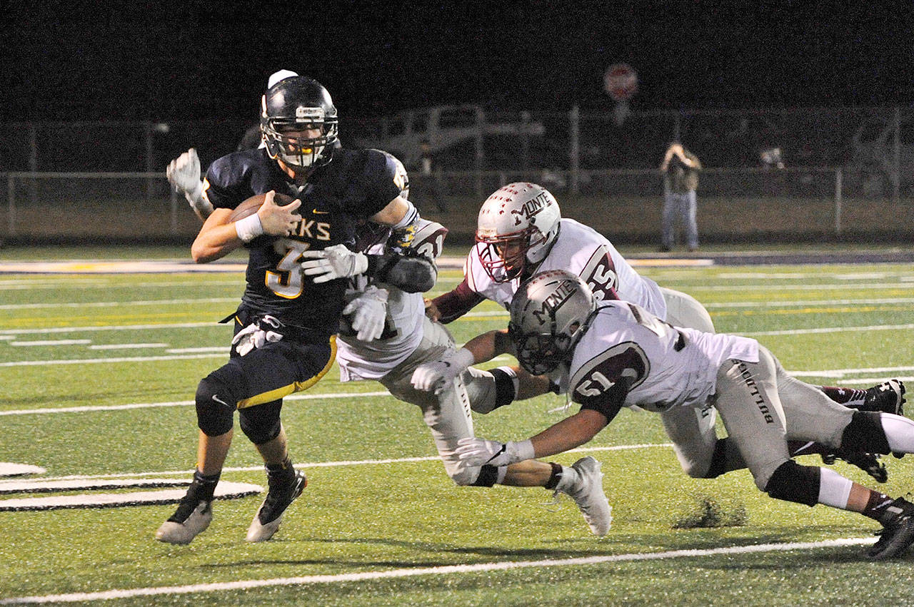 Lonnie Archibald/for Peninsula Daily News Forks’ Brett Moody, left, escapes Montesano defenders from left, Carson Klinger (31), Kai Olsen (55) and Ben Sowers (51).