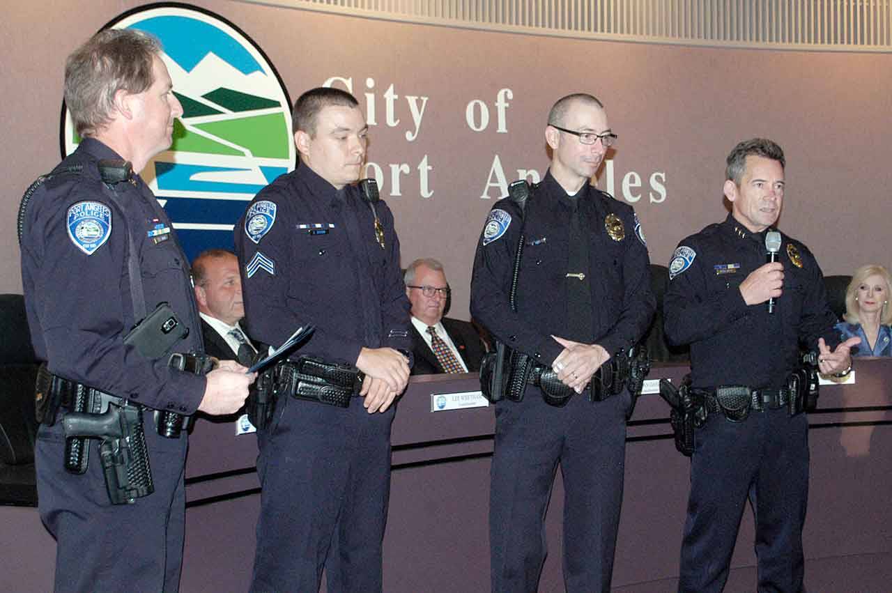 Port Angeles Police Cpl. Sky Sexton and Officer Jared Tait receive the Law Enforcement Life Saving Medal from Deputy Chief of Police Jason Viada and Chief Brian Smith at the Port Angeles City Council meeting Tuesday. Sexton and Tait were credited for their actions after a vehicle they were chasing landed upside-down in the Valley Creek estuary in the early morning hours of Sept. 8. (Rob Ollikainen/Peninsula Daily News)