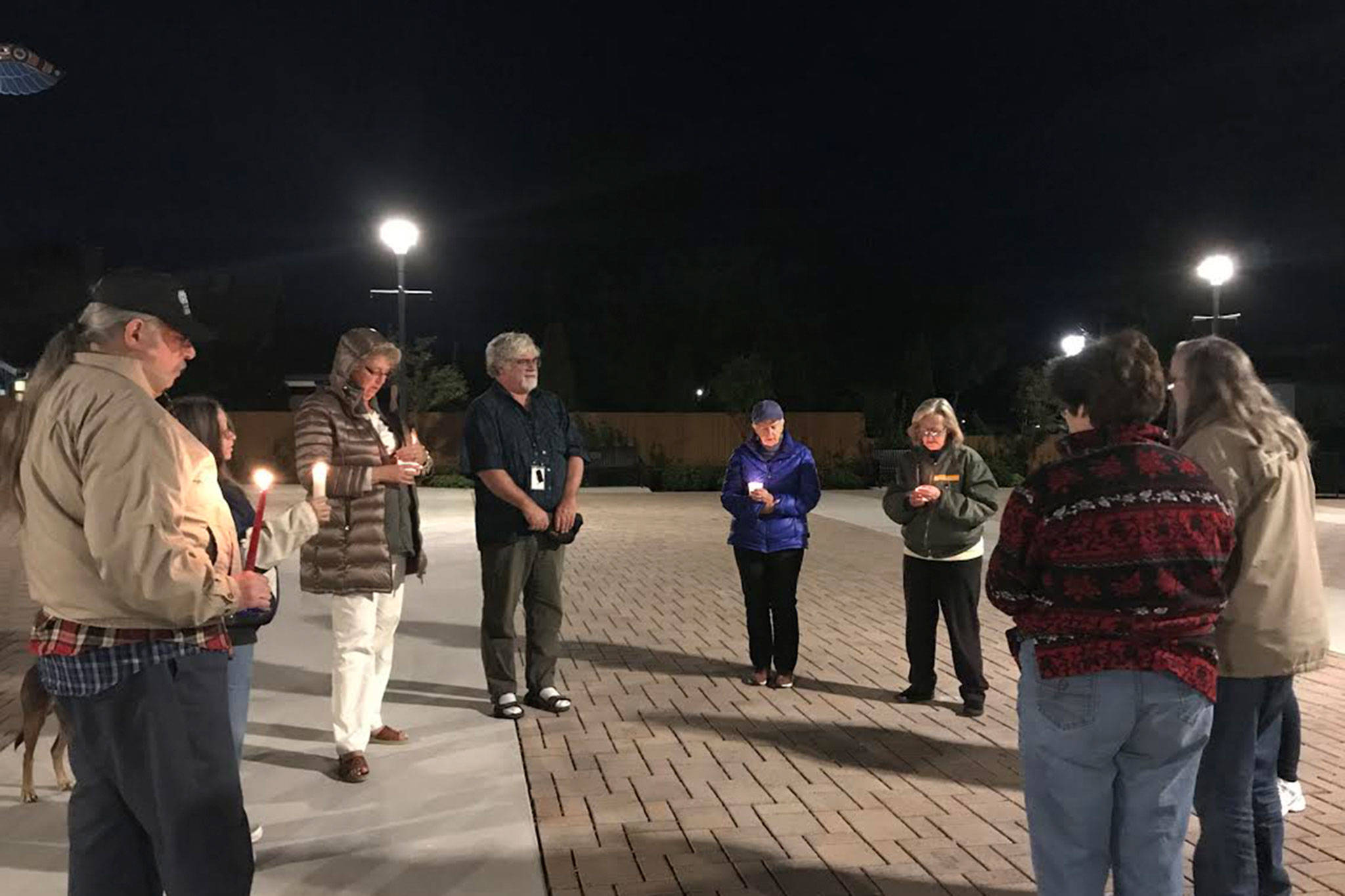 A group of more than 10 Sequim residents gathers at 7:30 p.m. Monday at the Sequim Civic Center to hold a candlelight vigil for victims of the Las Vegas shooting that killed more than 50 people and injured more than 500 last Sunday at a country music concert. (Erin Hawkins/Olympic Peninsula News Group)