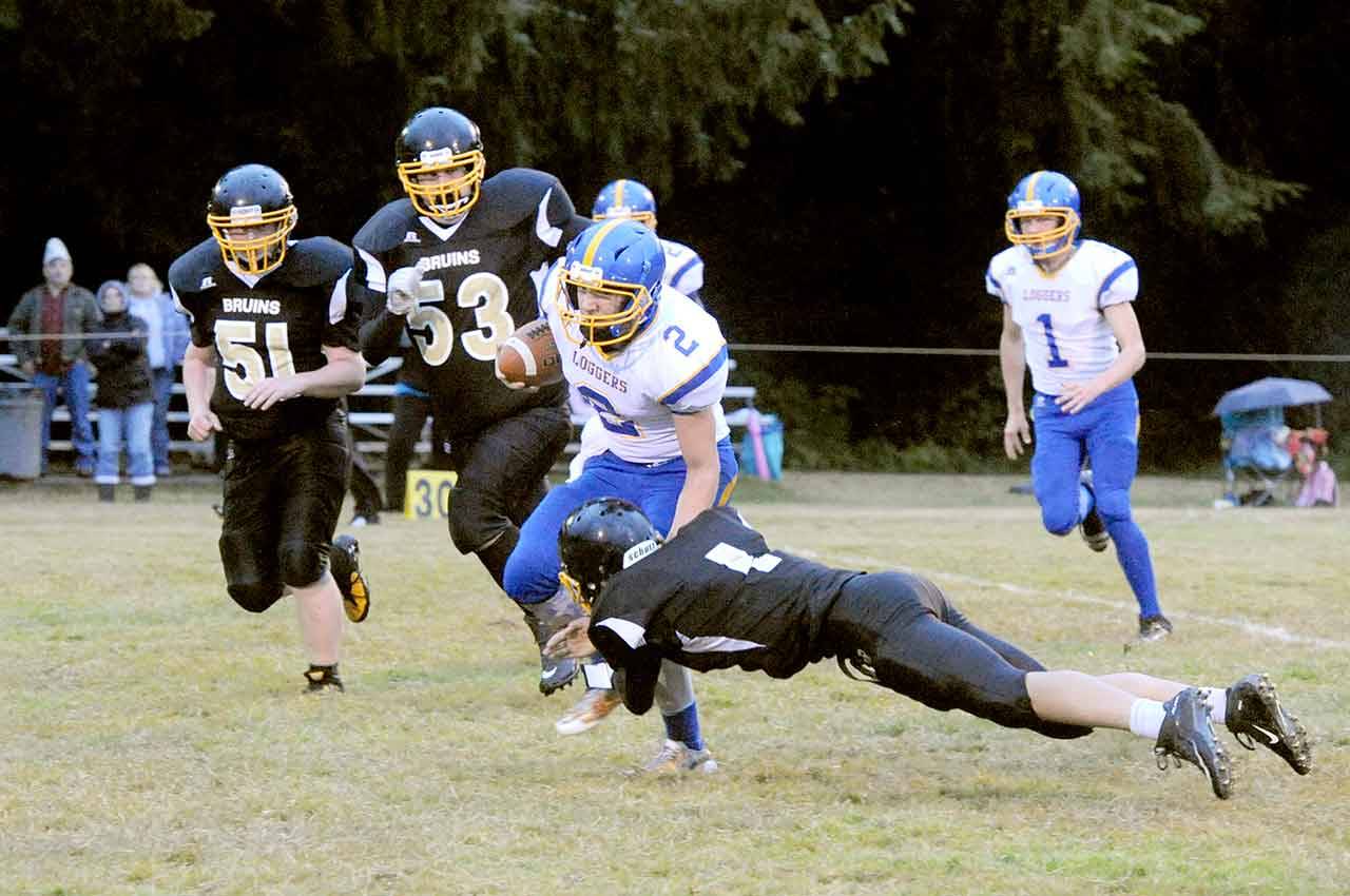 Crescent&rsquo;s Robert Cox (2) is stopped by Clallam Bay&rsquo;s Ryan Strid (1). Also in on the action are Bruins Anthony McGraw (51) and Eric Strid (53). Crescent&rsquo;s Fischer Hartley (1) trails the play. (Lonnie Archibald/for Peninsula Daily News).