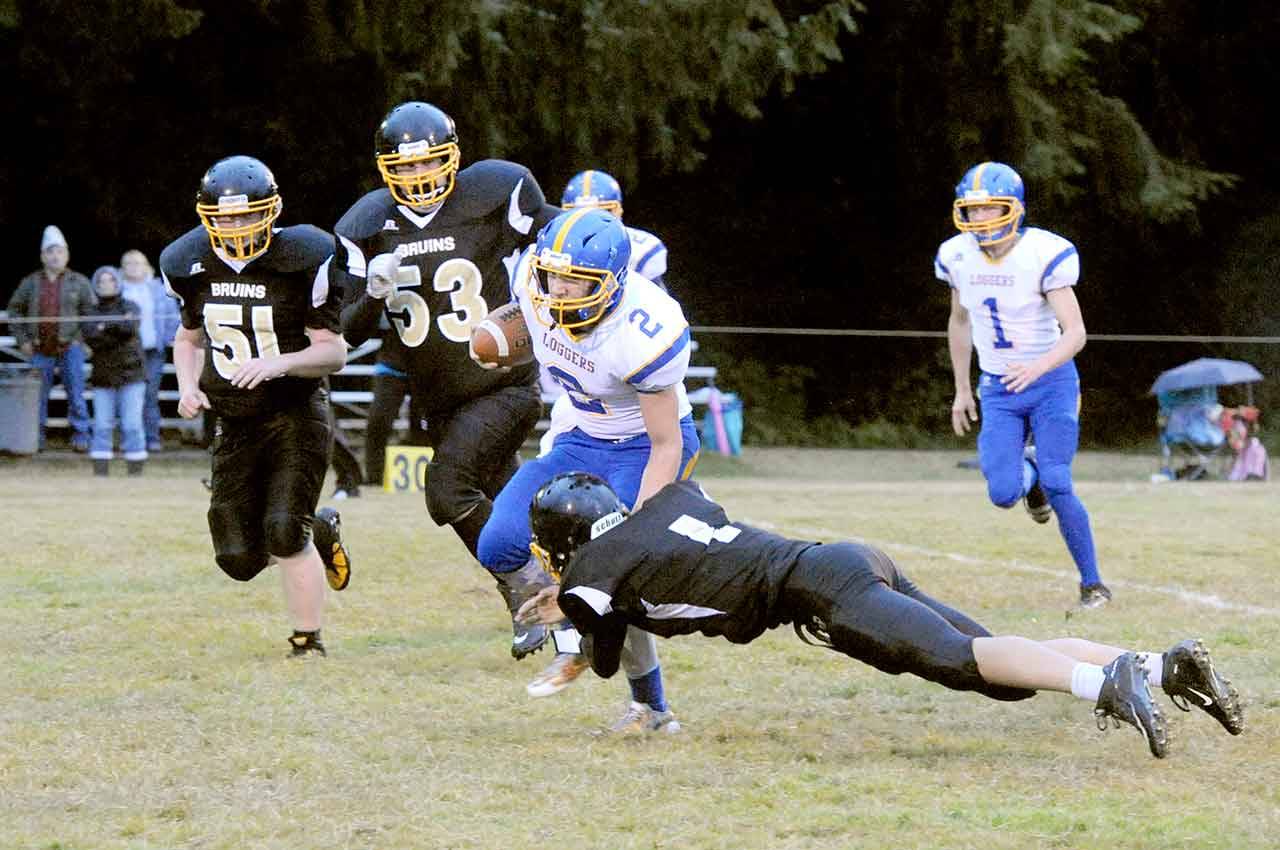 Crescent’s Robert Cox (2) is stopped by Clallam Bay’s Ryan Strid (1). Also in on the action are Bruins Anthony McGraw (51) and Eric Strid (53). Crescent’s Fischer Hartley (1) trails the play. (Lonnie Archibald/for Peninsula Daily News).