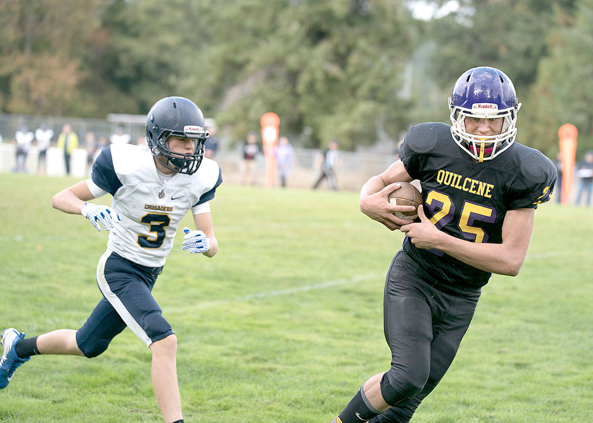 Quilcene’s Robert Comstock III outruns Tacoma Baptist’s Matthew Kessel, (3), taking a pass 47 yards for a touchdown in the Rangers’ 66-26 win Saturday over the Crusaders. (Steve Mullensky /For Peninsula Daily News)