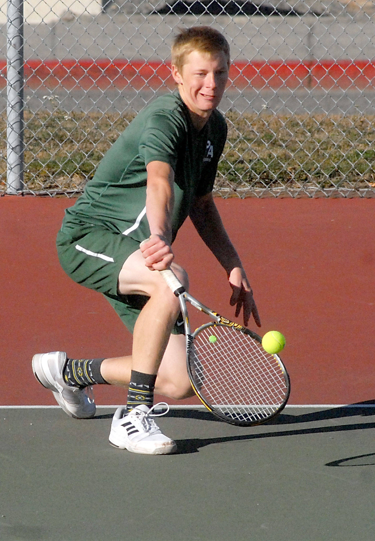 Port Angeles’ Hayden Woods returns the ball in his singles match against Kingston’s Ethan Griffin on Tuesday at Port Angeles High School.                                Keith Thorpe/Peninsula Daily News
