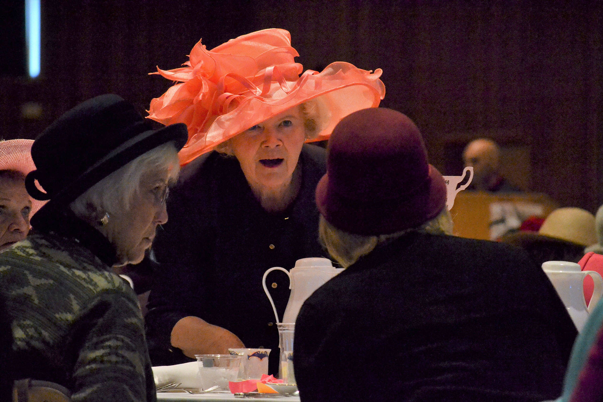 Matthew Nash/Olympic Peninsula News Group                                Shirley Sutterlin serves water to Evelyn and Sandy Bequette at the Mad Hatter’s Tea.