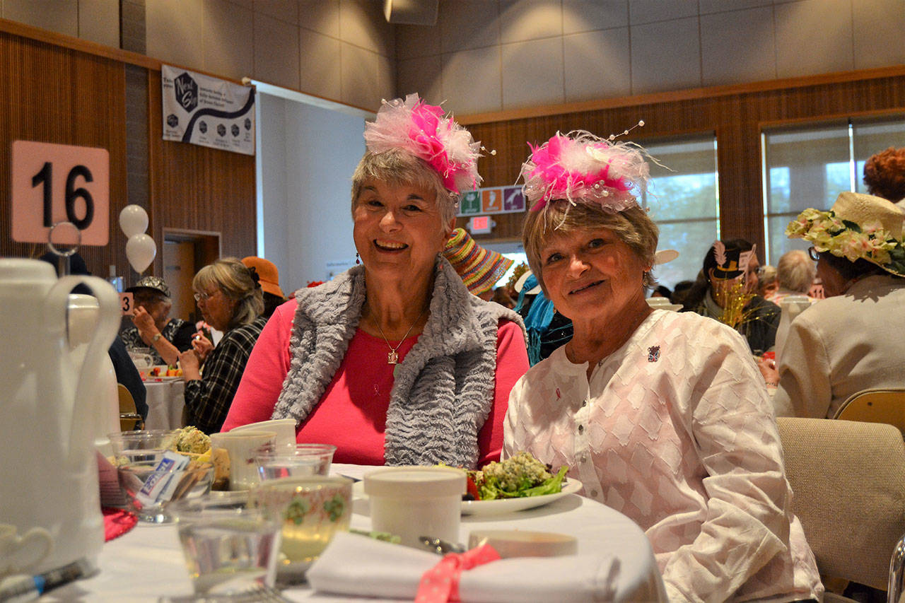 Matthew Nash/Olympic Peninsula News Group                                Friends Judy Kelley and Shannon Archbold, both of Sunland, smile in their custom hats that Archbold made at the Mad Hatter’s Tea earlier this month.