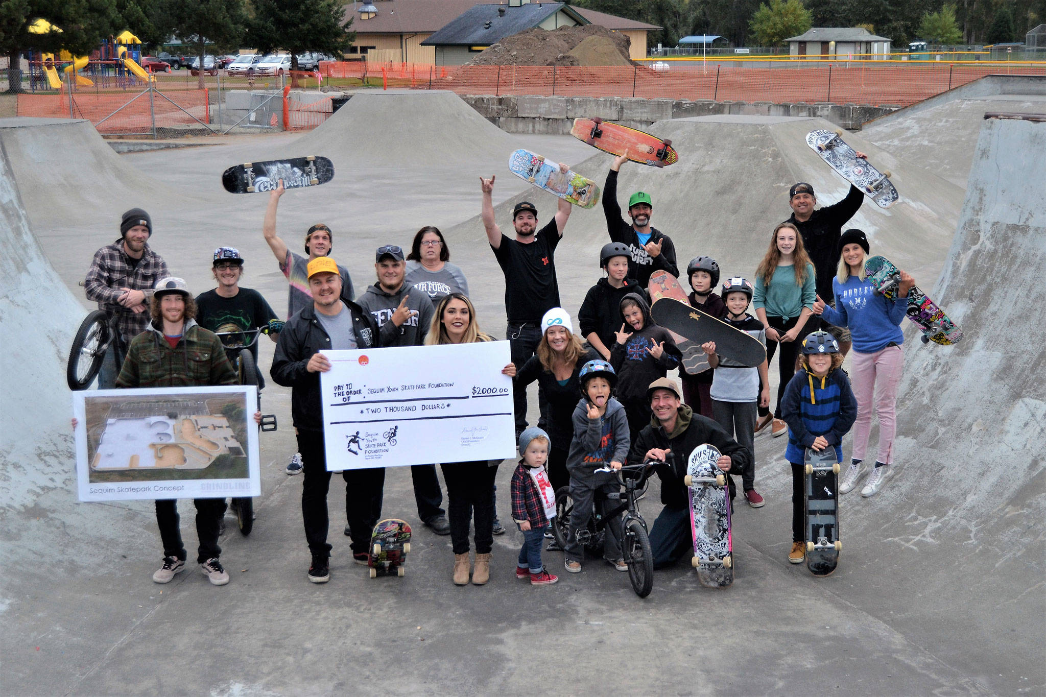 Matthew Nash/Olympic Peninsula News Group                                Local riders at Sequim Skate Park gather to accept a $2,000 check Oct. 6 from the TeamInspire Project, founded by members of the band Emblem3. Funds will go towards a goal of expanding and fixing the existing skate park.