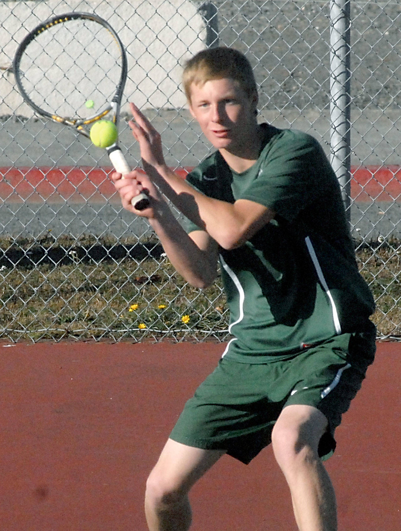 OLYMPIC LEAGUE TENNIS TOURNAMENT Hayden Woods raising a racquet for Port Angeles Peninsula Daily News