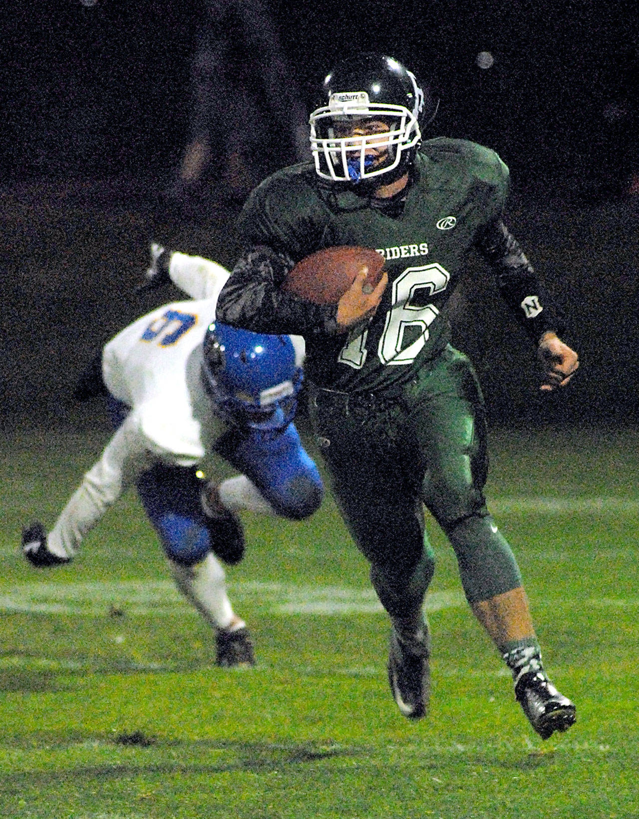Port Angeles’ Easton Joslin rushes in the second quarter after evading the defense of Bremerton’s Abraham Parish on Friday at Civic Field.                                Keith Thorpe/Peninsula Daily News