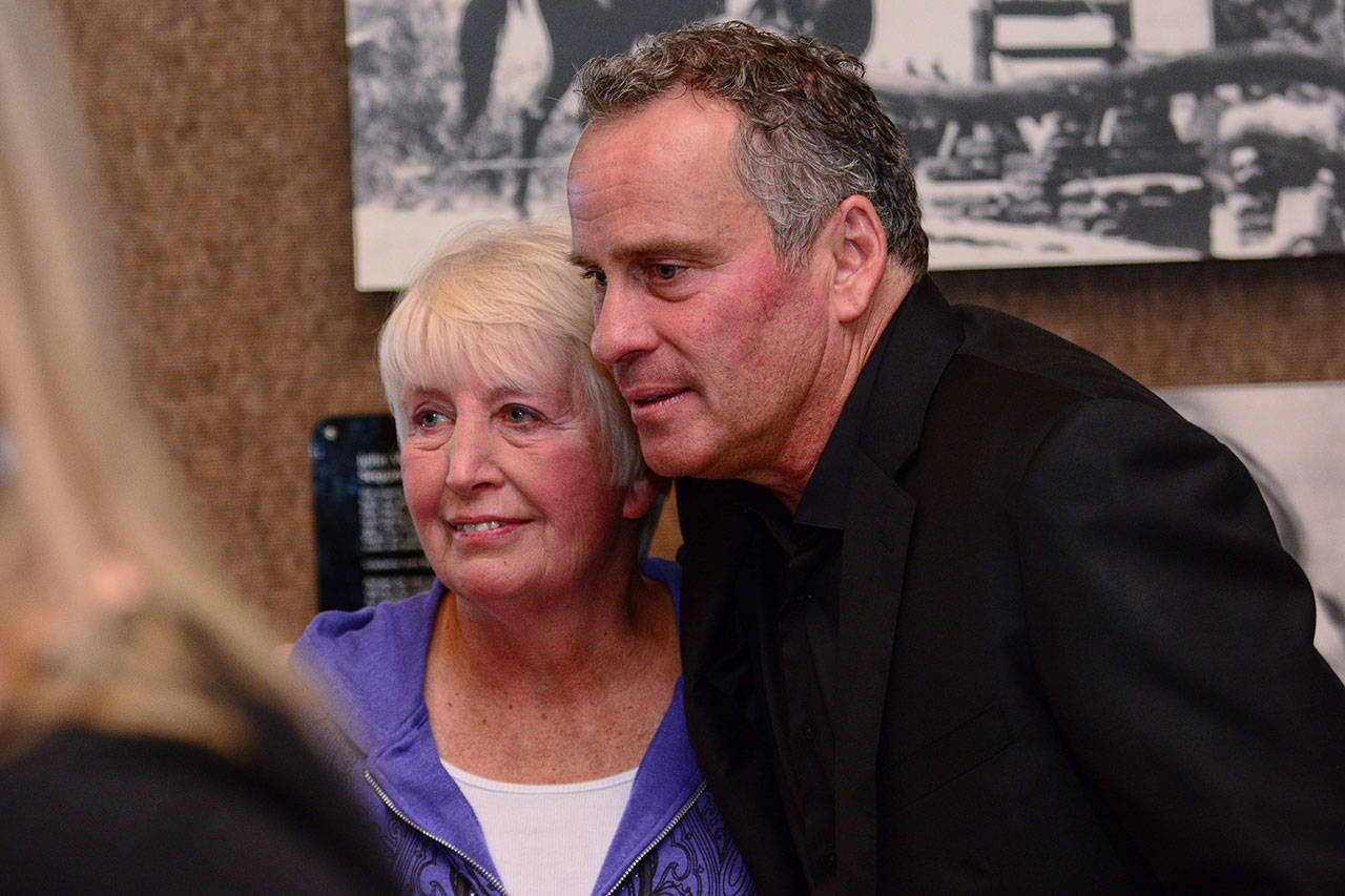 Betty Hendricks and Ethan Wayne stand together Saturday during the dedication of a room at John Wayne Marina in honor of Hendricks’ late husband, Jerry Hendricks, a former Port of Port Angeles executive director. (Jesse Major/Peninsula Daily News)