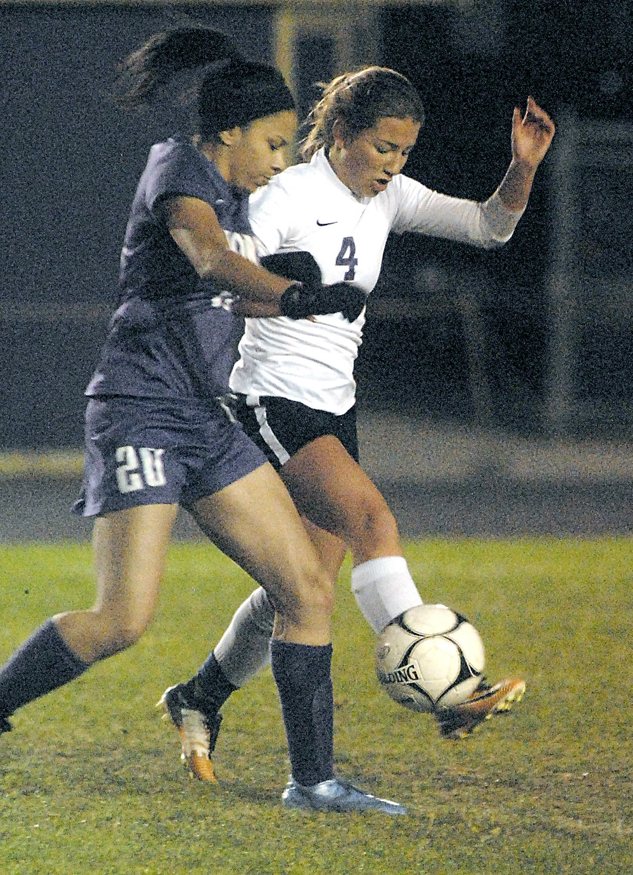 Keith Thorpe/Peninsula Daily News                                Sequim&rsquo;s Natalya James, right, slips the ball past North Kitsap&rsquo;s Isla Lester during the Wolves&rsquo; 1-0 loss.