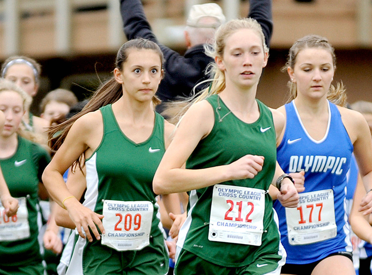 Port Angeles’ Ella Holland, left and Gracie Long, center, begin their race at the Olympic League Cross-Country Championships on Thursday. The Port Angeles girls won as a team as Holland finished sixth and Long 13th. (Michael Dashiell/Olympic Peninsula News Group)