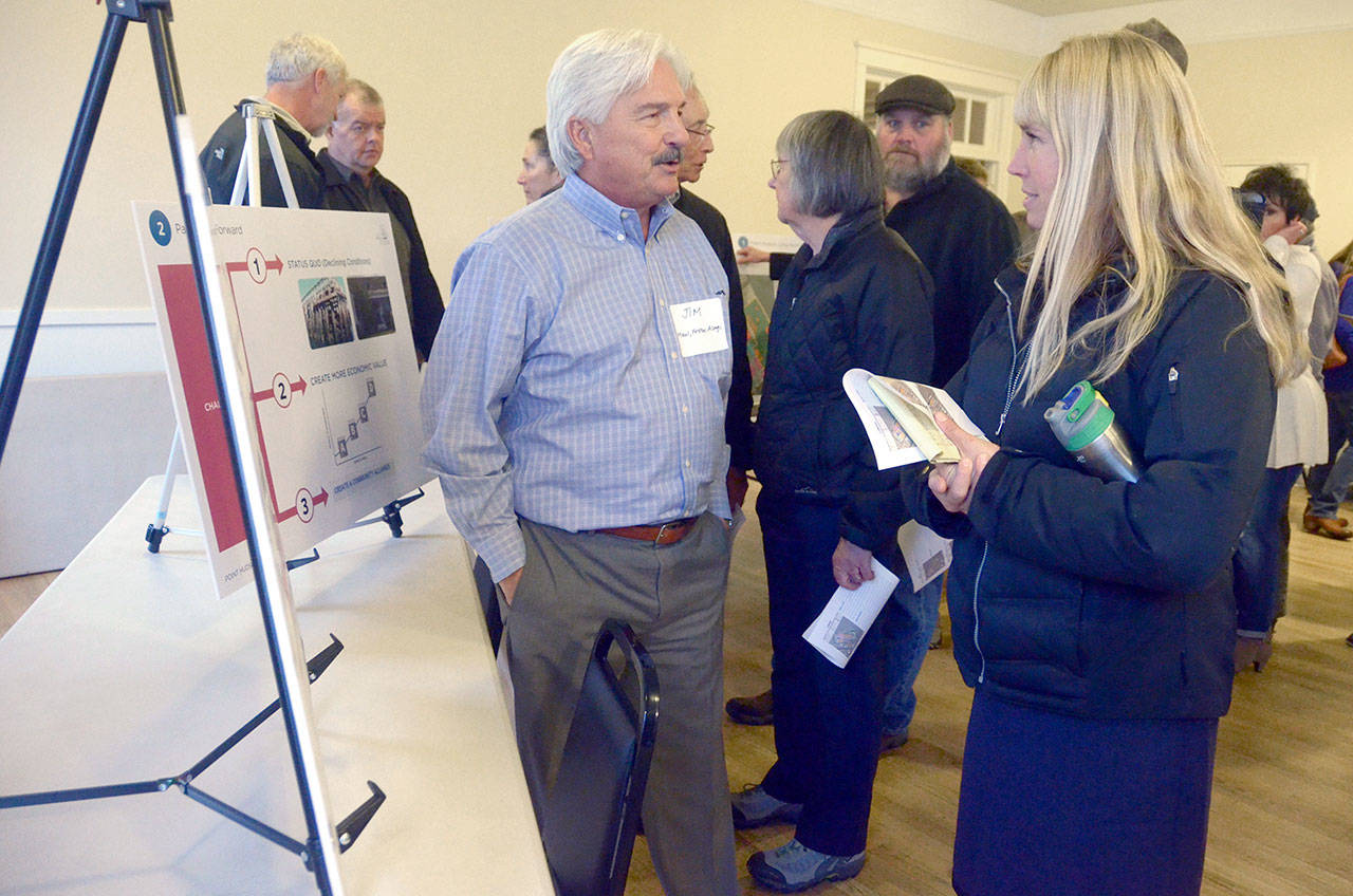 Jim Darling from Maul Foster & Alongi, the Port of Port Townsend’s consultant on Point Hudson, presents information to Port Townsend restaurant owner Kris Nelson at an open house. (Cydney McFarland/Peninsula Daily News)