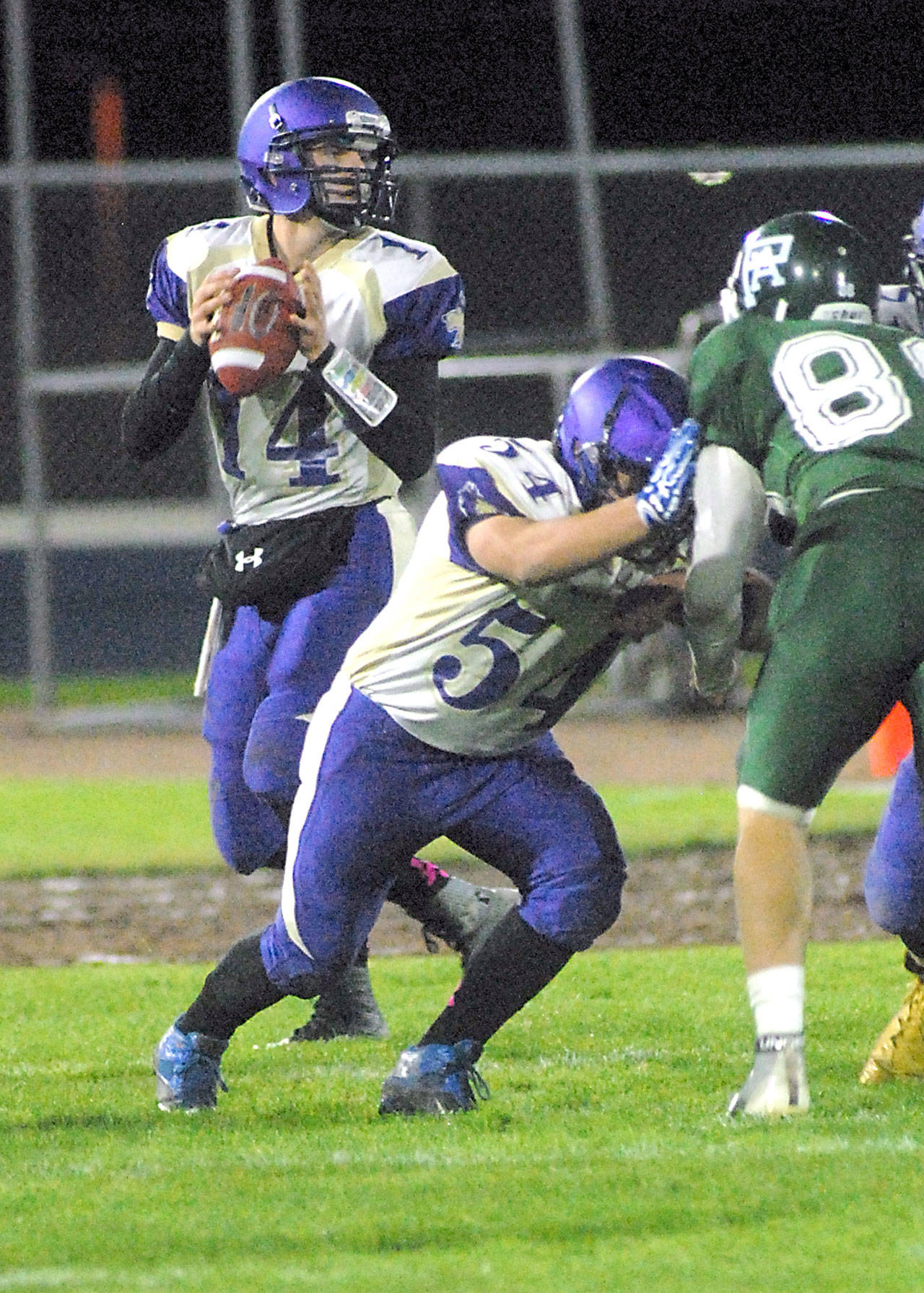 Sequim quarterback Riley Cowan, left, drops back to pass as teamate Adam DeFillipo blocks Port Angeles’ Dominick Timperio during their matchup last week at Port Angeles Civic Field.                                Keith Thorpe/Peninsula Daily News