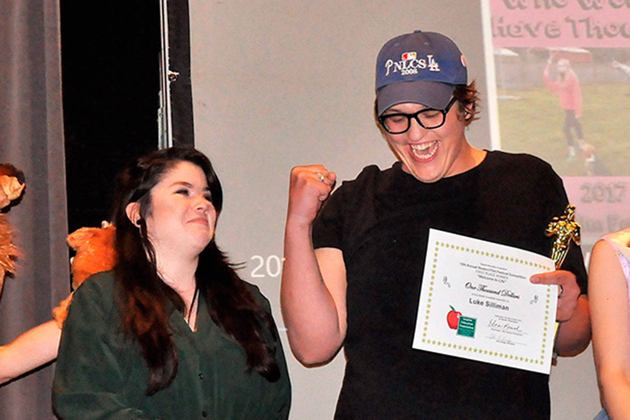Matthew Nash/Olympic Peninsula NewsGroup                                Luke Silliman celebrates winning the audience choice award, or the Elkie, at the Sequim Education Foundation’s Student Film Festival on April 21 at Sequim High School with his friend Emma Gallaher. Their film “Welcome to Life” also won first place and a $1,000 scholarship.