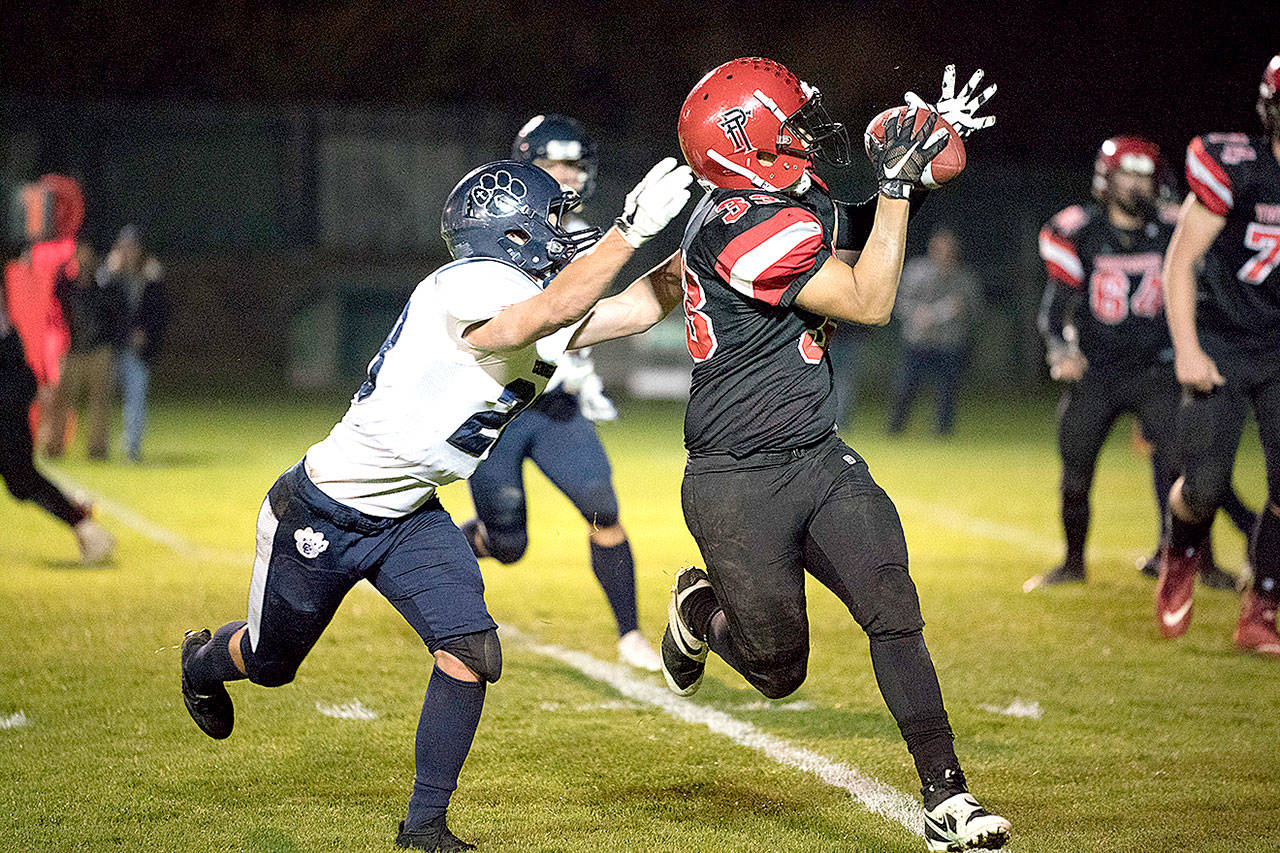 Steve Mullensky/for Peninsula Daily News Port Townsend Redhawk Jacob Boucher makes a catch for a short yardage gain during a game against Cascade Christian on Friday at Memorial Field in Port Towsend.