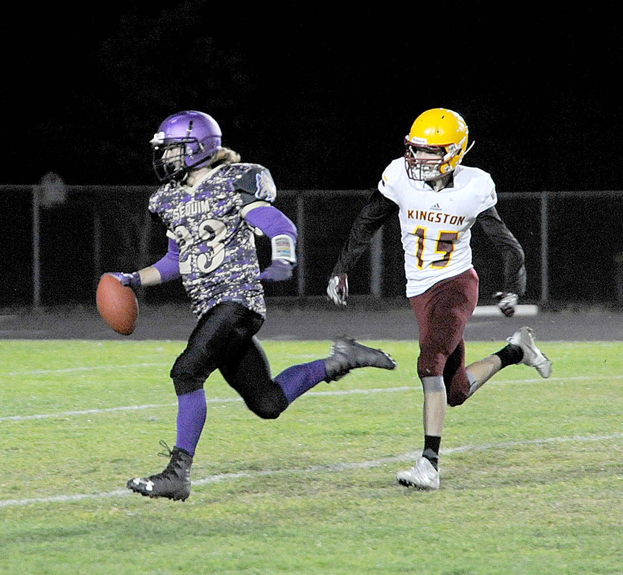 Sequim’s Gavin Velarde runs away from Kingston defender James Dillow for a 65-yard touchdown. It was one of five Velarde touchdowns on the night in Sequim’s 48-6 win. (By Michael Dashiell/Olympic Peninsula News Group)