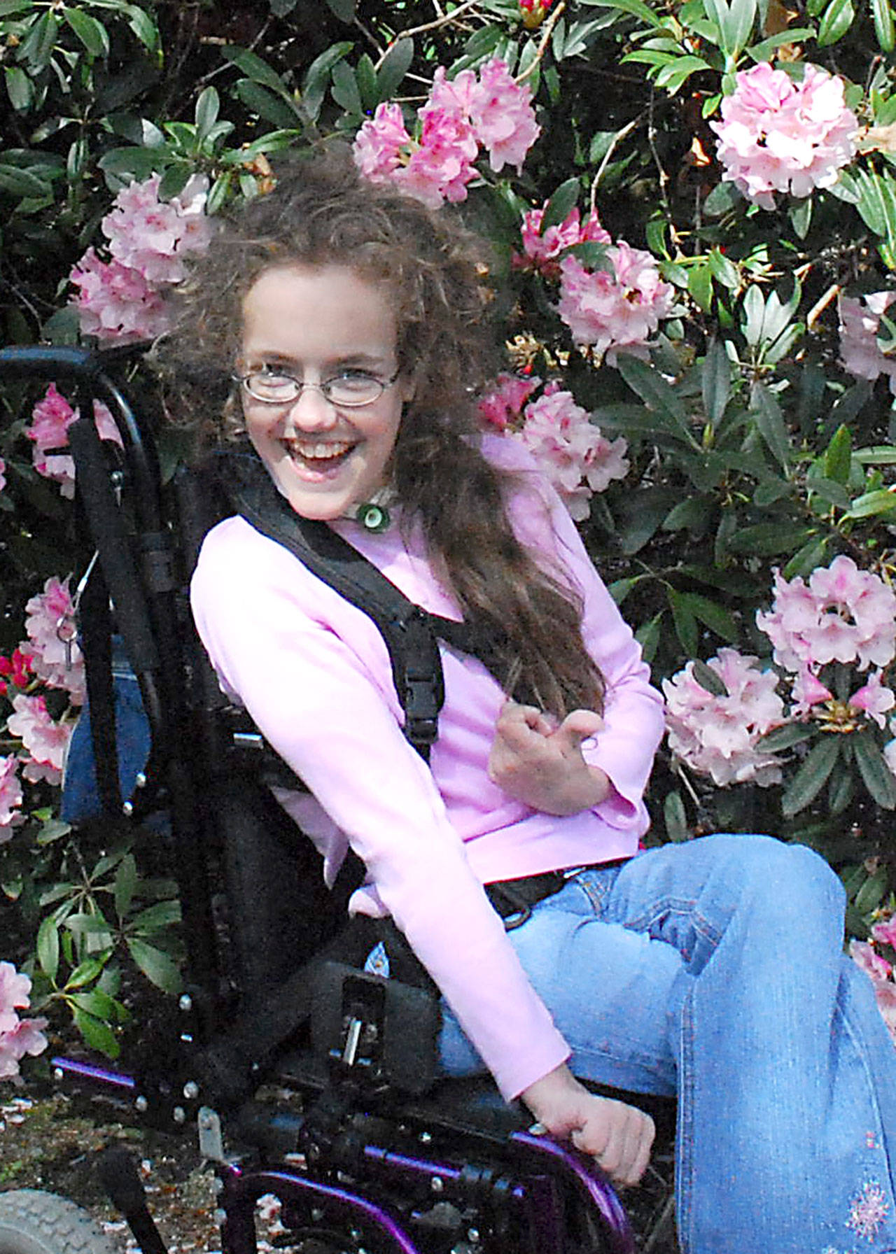 Quinn Redlin Kintner gives a thumbs up in her manual wheelchair. (Kelsey Redlin)