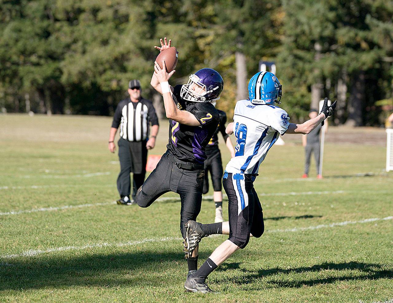 Quilcene’s Bishop Budnek (2) intercepts in a pass intended for Seattle Lutheran’s Hayden Bushfield onSaturday in Quilcene. Budnek ran the ball back 33 yards to set up a touchdown. (Steve Mullensky/for Peninsula Daily News)