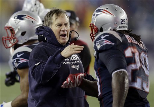 New England Patriots head coach Bill Belichick congratulates LeGarrette Blount after his touchdown during the second half of the NFL football AFC Championship game against the Indianapolis Colts. (The Associated Press)