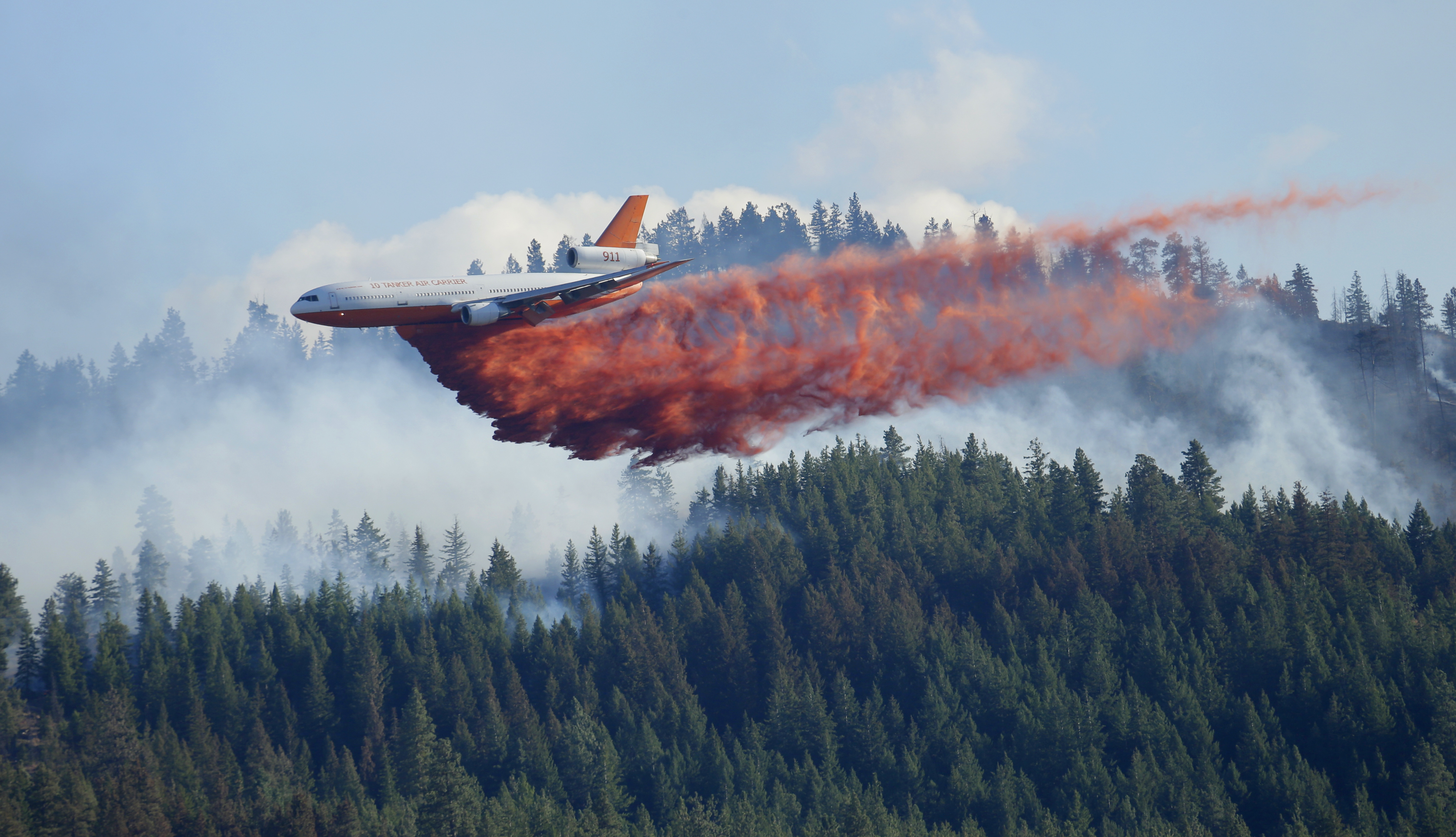 A DC-10 tanker airplane drops fire retardant on a wildfire north of Twisp in Okanogan County on Friday. The Associated Press (Click on image to enlarge)