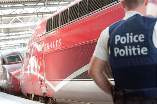 A member of the Belgian police stays next to a high-speed Thalys train at the Brussels Midi - Zuid train station on Saturday. The Associated Press