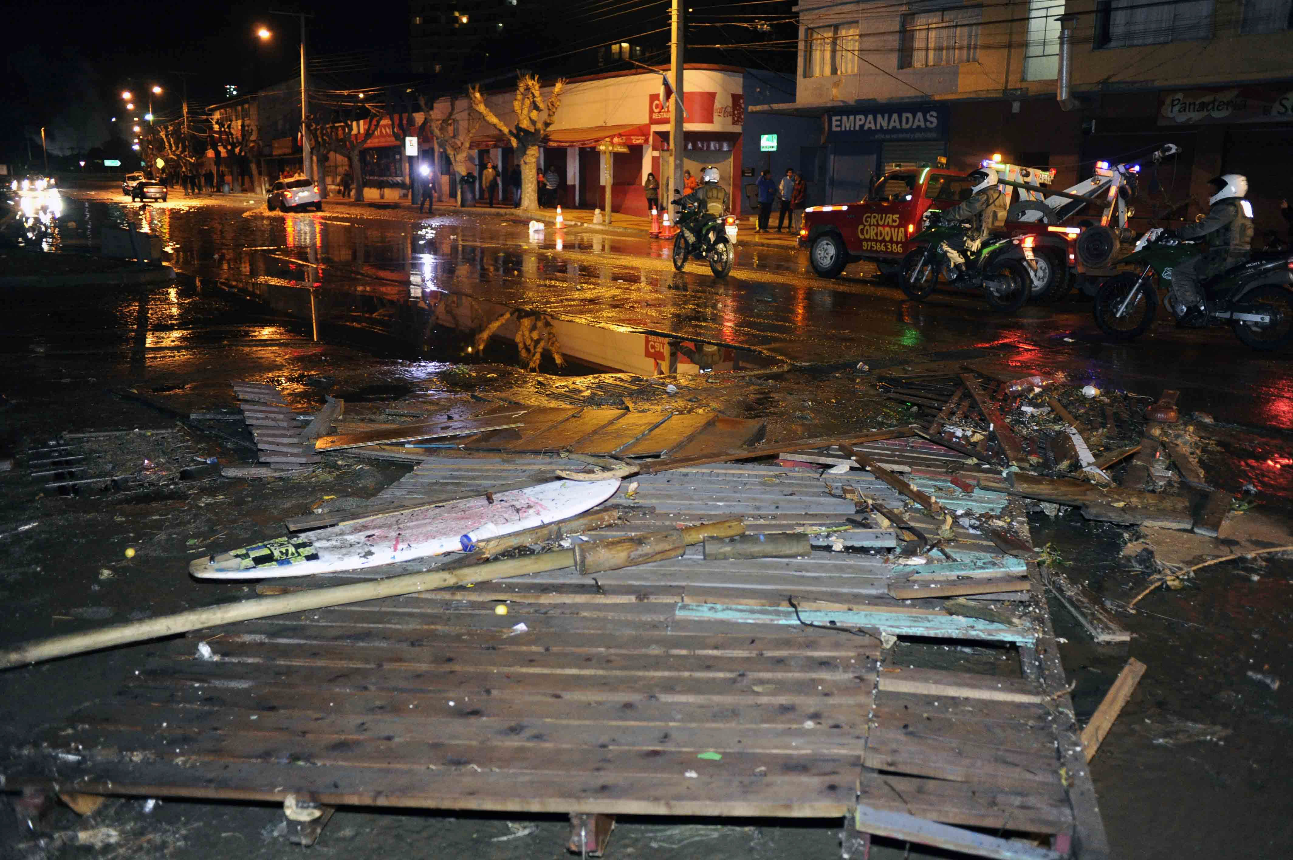 Police patrol a debris strewn street in Valparaiso