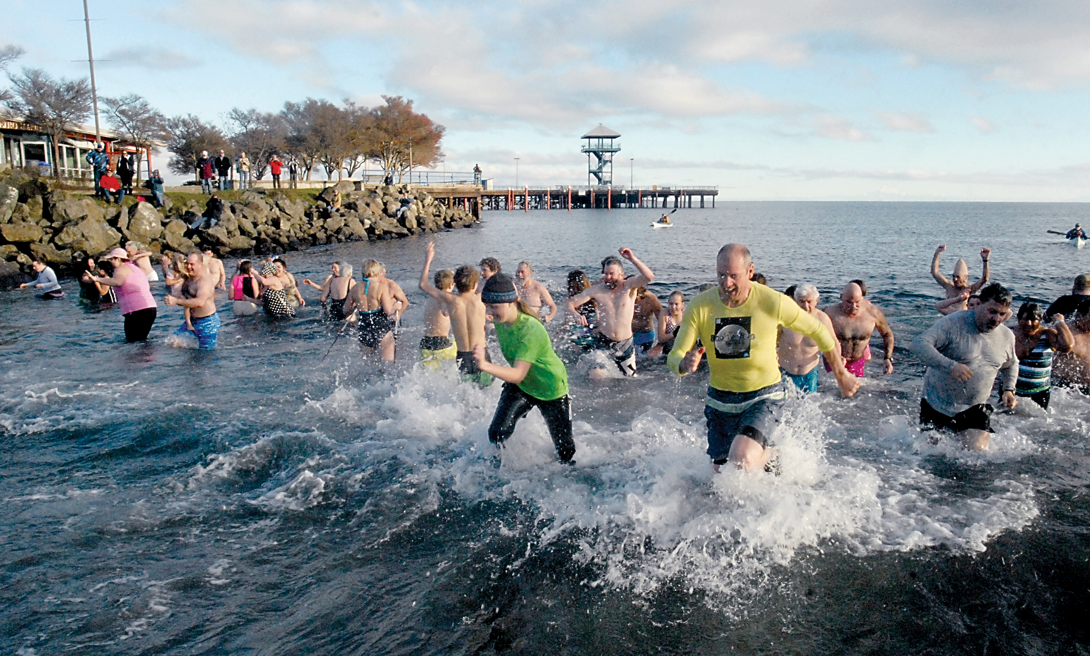 Participants in the 2016 Port Angeles Polar Bear Plunge dash in and out of the chilly water of Port Angeles Harbor at Hollywood Beach on New Year's Day. (Keith Thorpe/Peninsula Daily News)