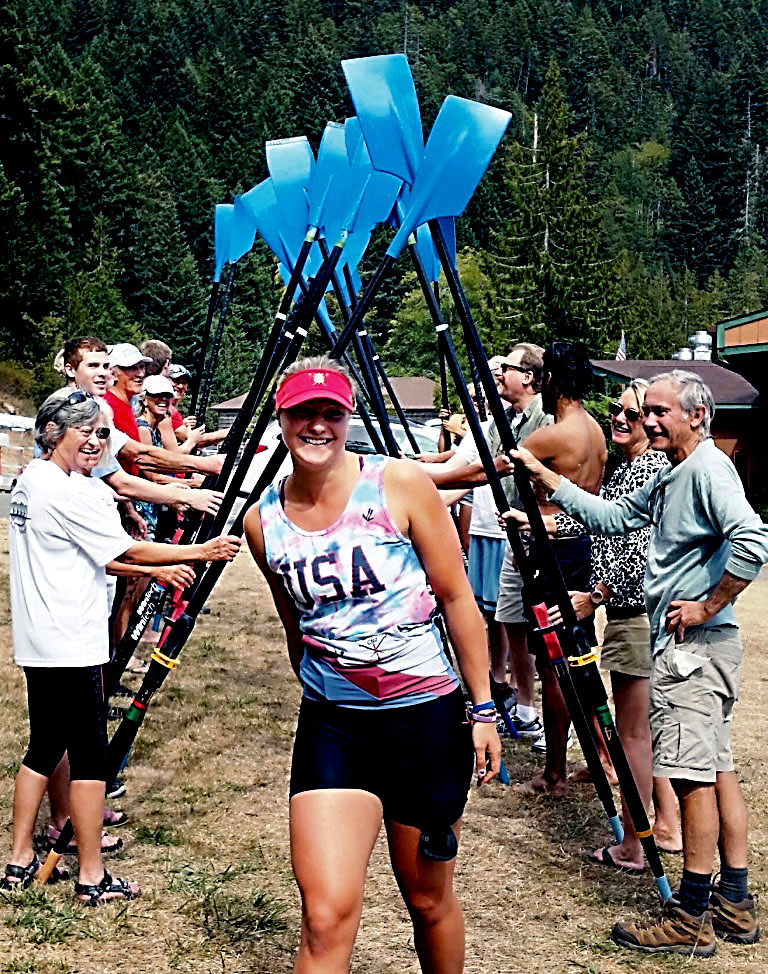Elise Beuke walks through a tunnel of oars at Log Cabin Resort soon after she returned from the Junior World Championships in Brazil. (Jim Heckman)