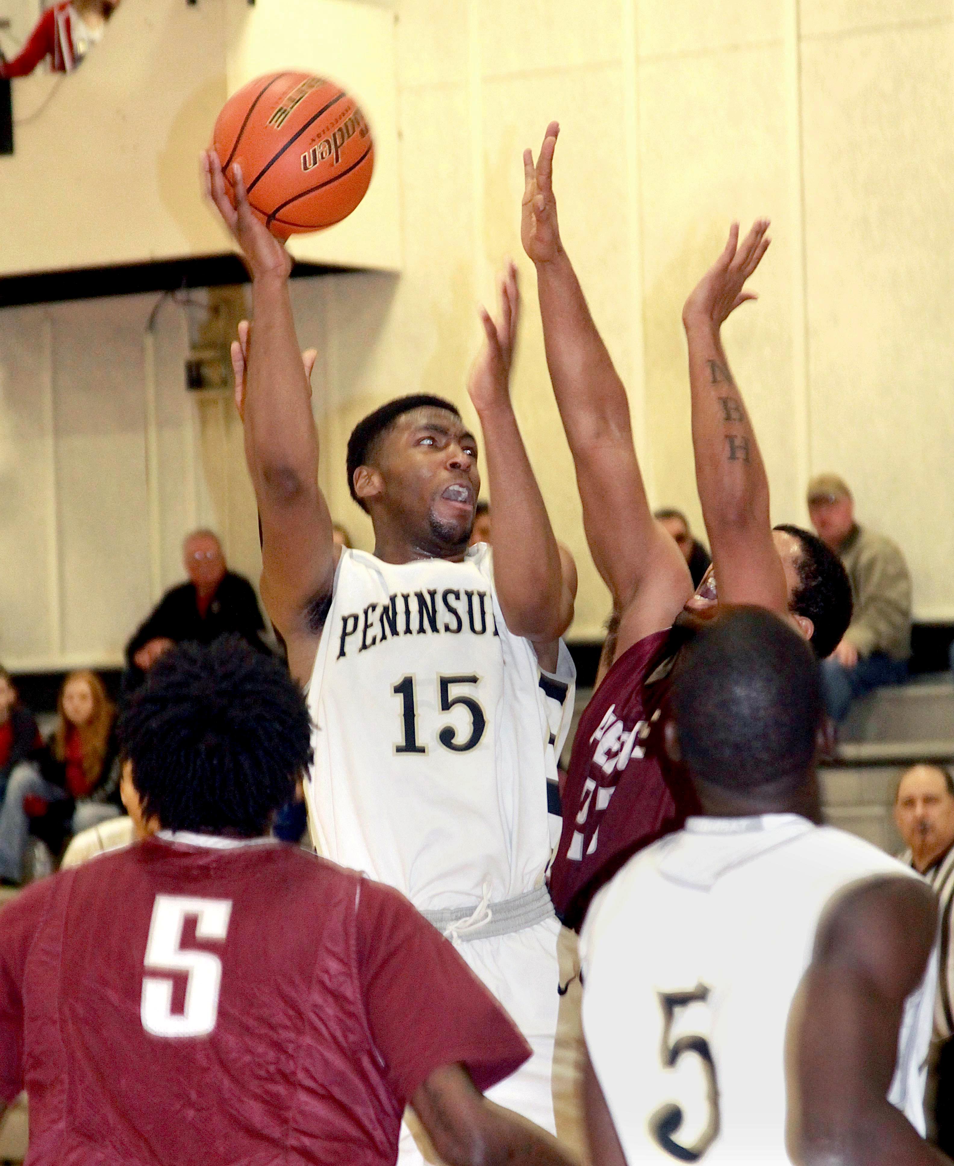 Peninsula College's Jeremiah Hobbs (15) rises up for a shot against the Pierce Raiders during the Pirates' 71-66 win. (Dave Logan/for Peninsula Daily News)