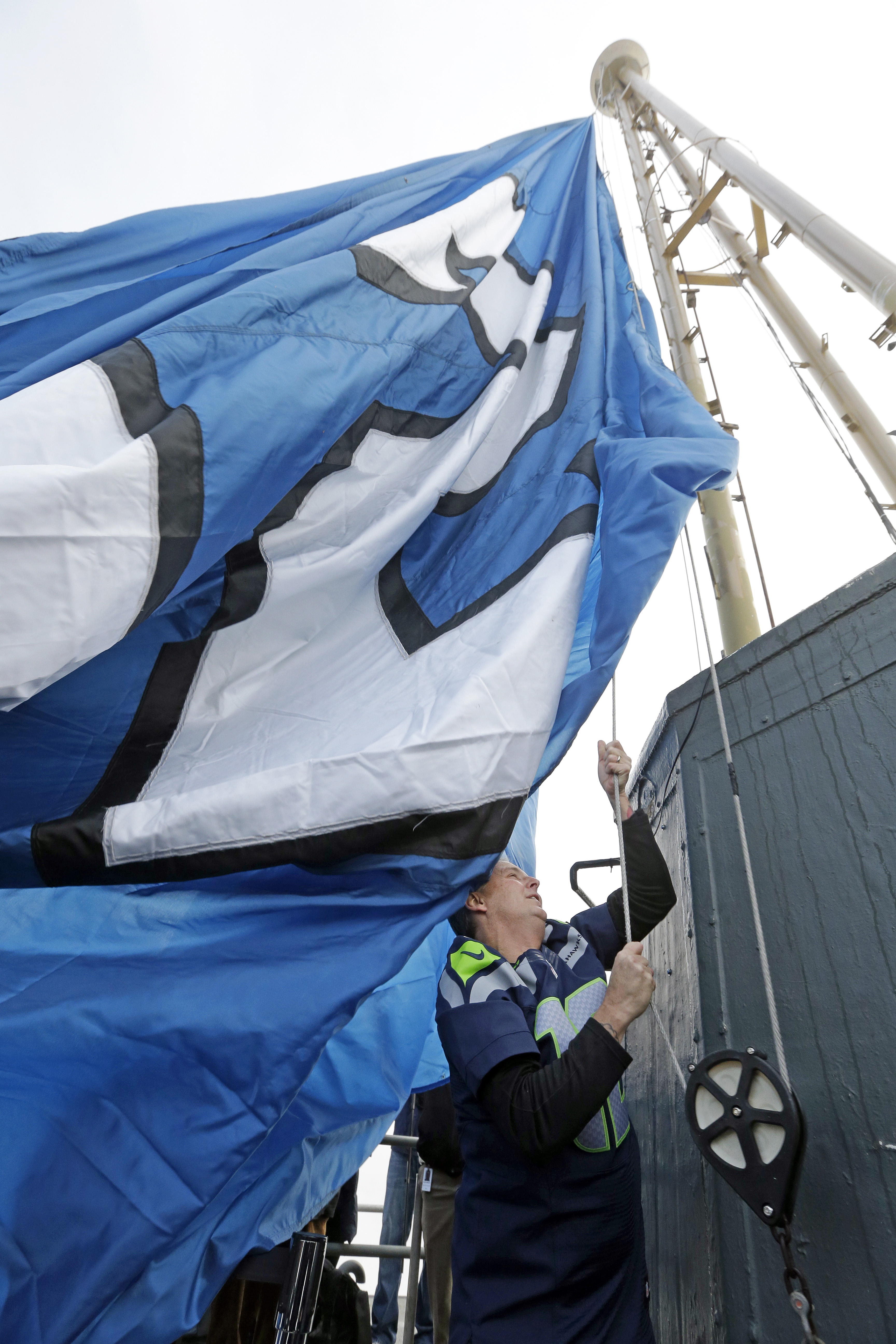 Pearl Jam lead guitarist Mike McCready raises a "12th Man" flag atop the Space Needle on Friday. (The Associated Press (Click on photo to enlarge))