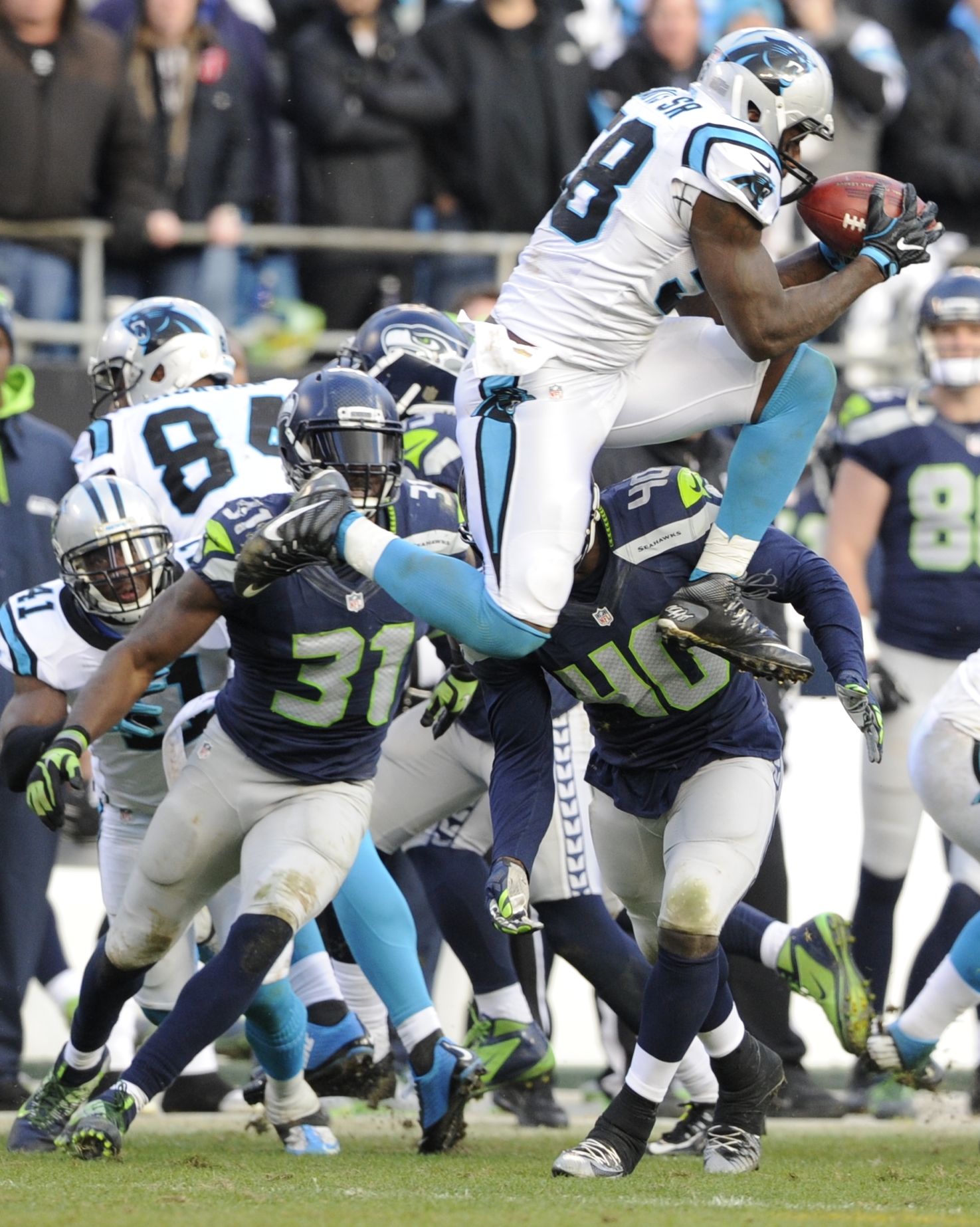 Carolina Panthers outside linebacker Thomas Davis (58) receives an on-side kick from the Seattle Seahawks during the second half of an NFL divisional playoff football game