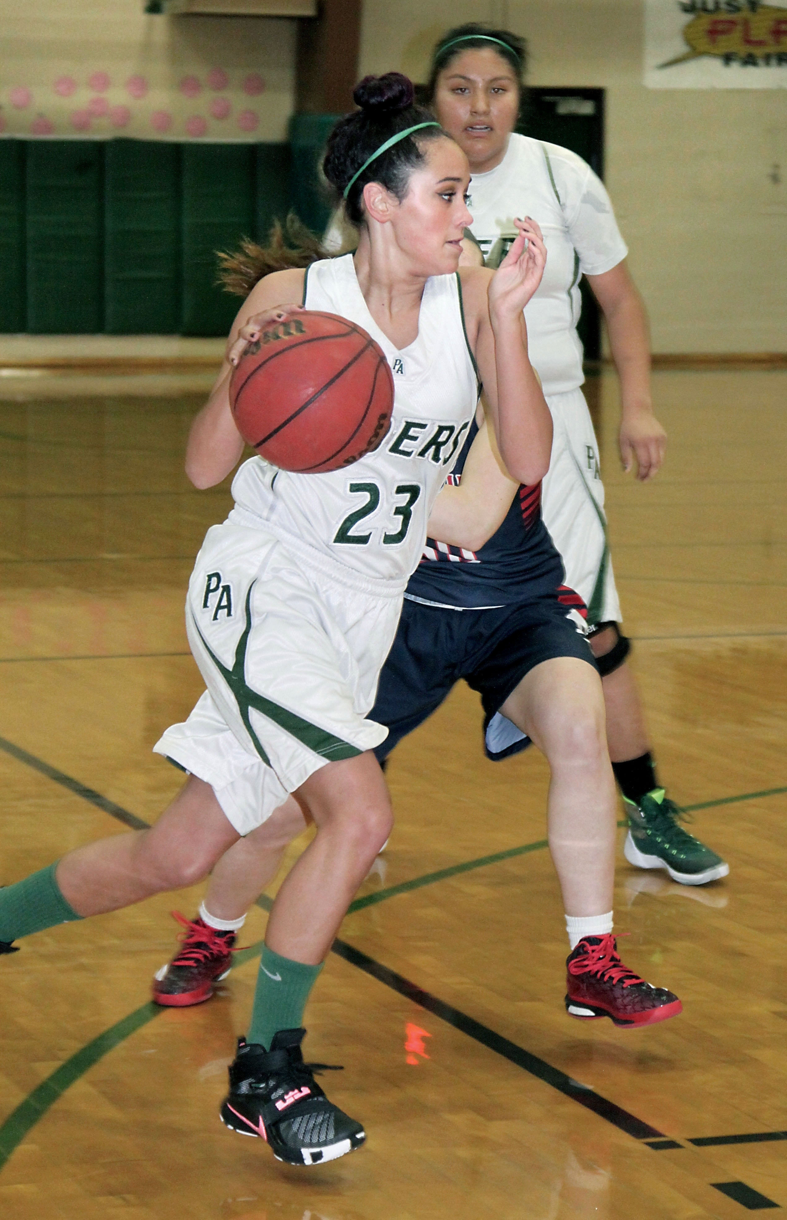 Port Angeles' Katyn Flores drives against Black Hills'  Rachel LeBelle. Flores went on to make the game-winning basket later in the game. (Dave Logan/for Peninsula Daily News)