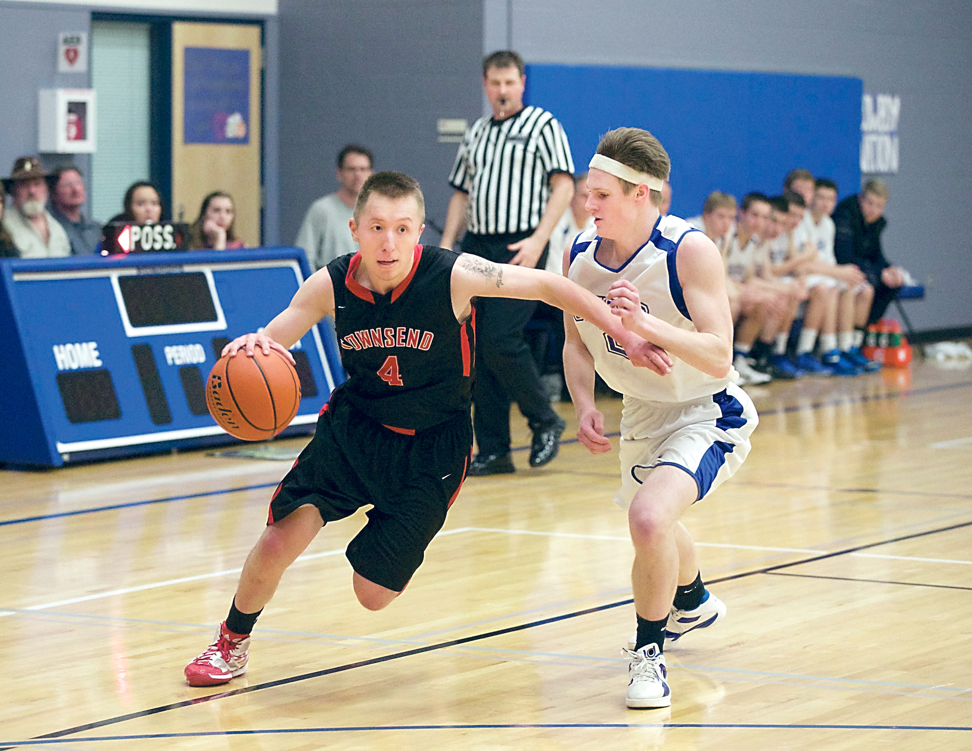 Port Townsend's Chris Adkins (4) drives around Chimacum's Myles Hundley for a basket during the Redhawks' 59-50 rivalry game victory in Chimacum on Monday. (Steve Mullensky/for Peninsula Daily News)