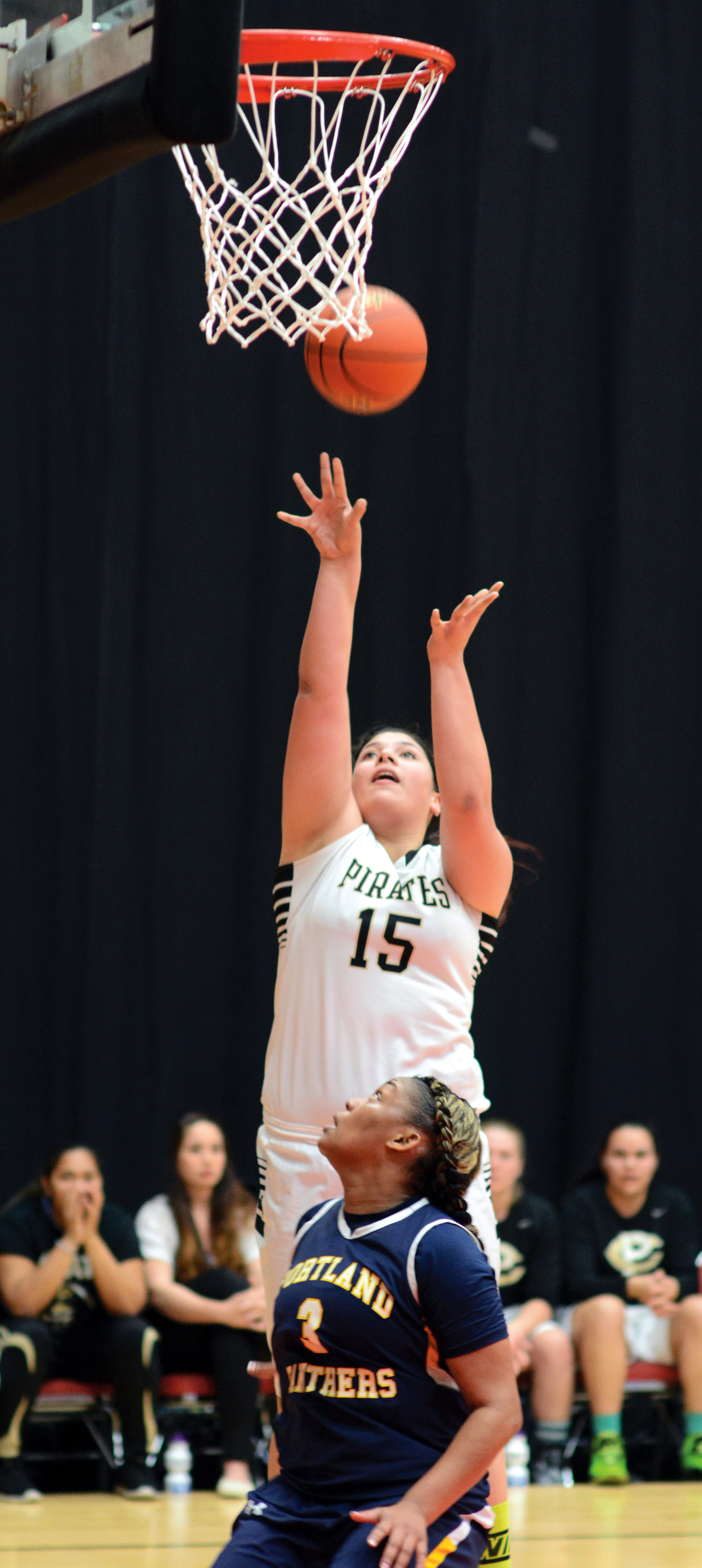 Peninsula's Gabi Fenumiai (15)goes for a layup against Portland's Shyanne Akles during the Pirates' 81-60 win to open the NWAC tournament. (Rick Ross)