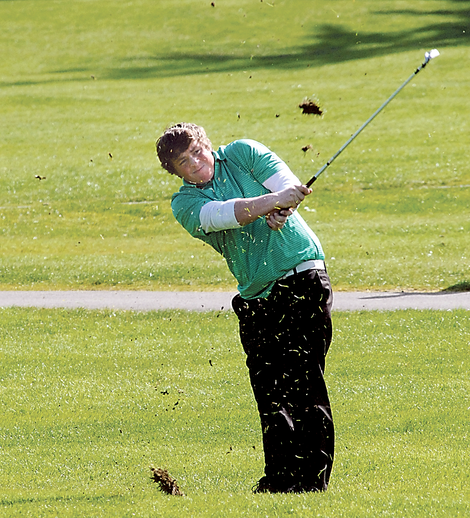 Port Angeles' Alex Atwell hits an iron to the green on the first hole at Peninsula Golf Course in Port Angeles on Wednesday in a match against Sequim. (Keith Thorpe/Peninsula Daily News)