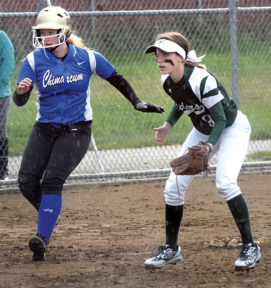 Chimacum's Shanya Nisbet watches the pitcher as Port Angeles third baseman Taylar Clark guards the bag during the Roughriders' 15-3 win. (Keith Thorpe/Peninsula Daily News)