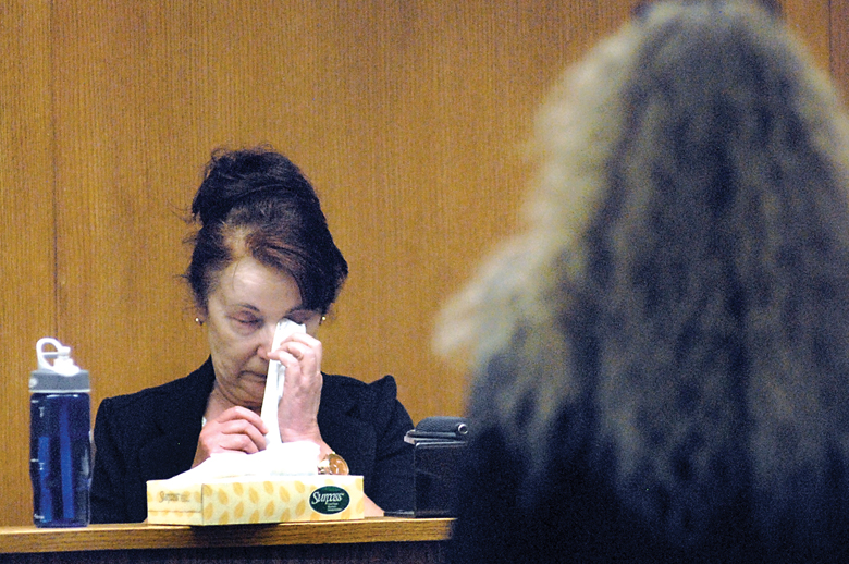 Former Port Angeles Finance Director Yvonne Ziomkowski wipes her eyes while giving testimony in her sex discrimination suit against the city as attorney Karen Unger
