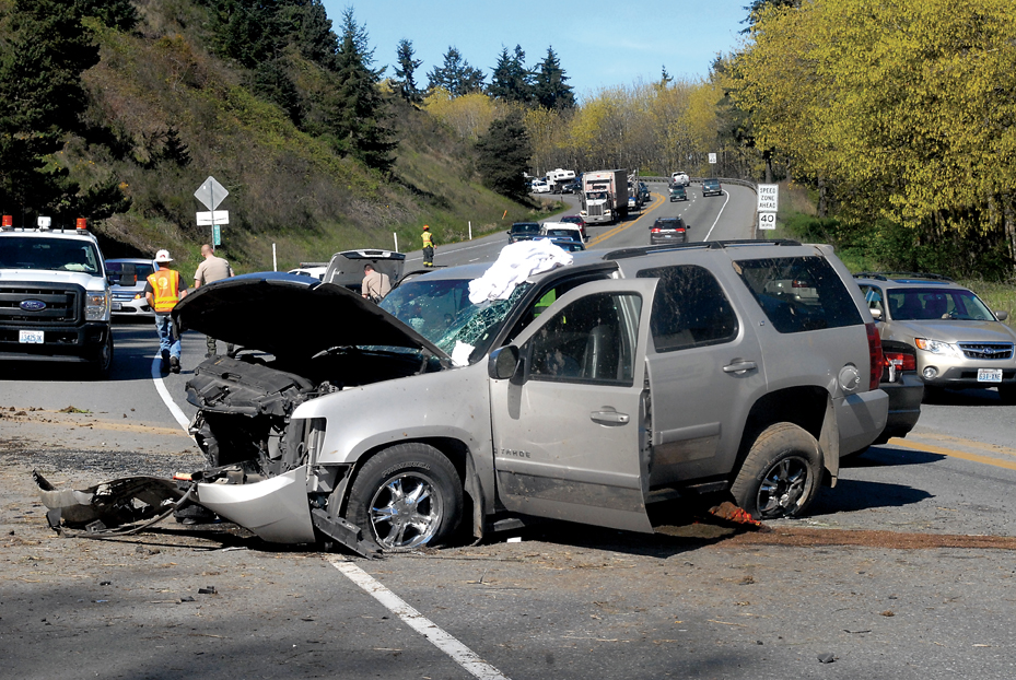A crashed sport utility vehicle blocks the eastbound lanes of U.S. Highway 101 near Morse Creek on Wednesday
